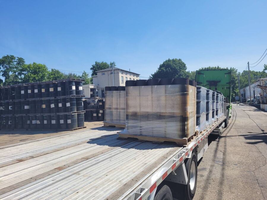 A GTI Transport flatbed loaded with dense crated and palletized freight