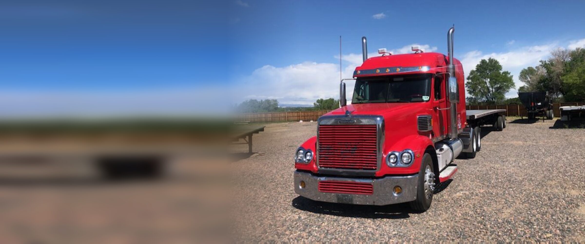 A red GTI Transport Freightliner coupled to a flatbed trailer at the company yard in Austin, Texas